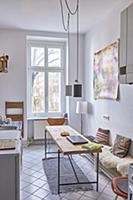 Table and bench in narrow kitchen in period apartm