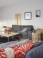 Grey couch, coffee table and baskets in living roo