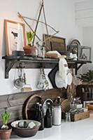 Ornaments in natural shades above grey desk in bed