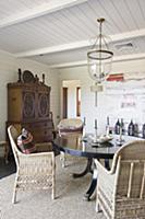 Wicker chairs at round table in dining room with w