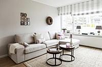 Pale sofa set and set of tables in living room