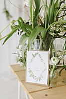 Spring flowers in glass vase and wedding card