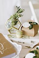 Flowers in geometric vase, gift box and macarons