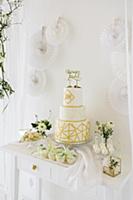 Wedding cake on sideboard and white paper decorati