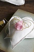 Silk flower on two hand-sewn fabric hearts