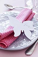 Place setting with napkin & 'Love' written on pape