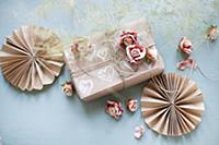 Paper rosettes, gift box and roses