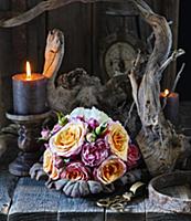 Bouquet of roses, lit candles and dried branches