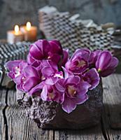 Arrangement of Cymbidium orchids on table