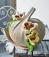 Day lilies arranged in large dry leaves