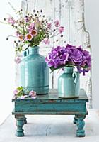 Japanese anemones and hydrangeas in turquoise vase