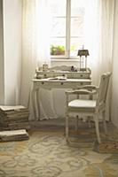 Romantic writing desk and upholstered chair in fro