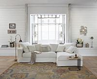 Pale sofa in front of bay window in rustic living 