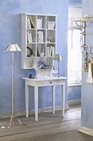 Console table below shelves mounted on pale blue w