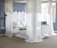 Blue walls and white four-poster bed in romantic b