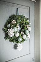 Festive door wreath with paper snowflakes and baub