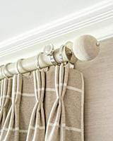 Beige checked curtain draped in elegant folds