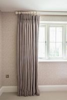 Grey curtain draped in elegant folds against spott