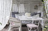 Vintage-style decoration in white wooden pavilion 