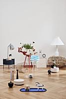 Various ornaments on side table and on pale parque