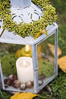 Lantern decorated with autumnal leaves and fruits