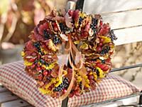 Wreath of autumn leaves and rose hips on chair bac