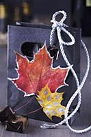 Small gift bag decorated with painted autumn leave