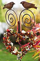 Heart-shaped wreath of rose hips & hydrangea flowe