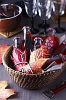 Basket of small bottles of drink decorated with pa