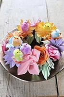 Chick decorations on wreath of colourful paper flo