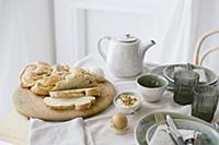 Sliced plaited yeast loaf on set table