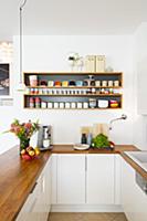 Kitchen counter with wooden worksurface below croc