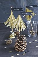 Paper fir trees with pennants on pine cones as nam