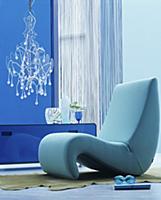 Organic easy chair in blue interior with modern ch