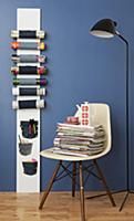 Magazine rack made from board and denim on blue wa