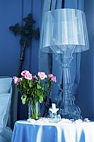 Lamp and roses on occasional table in Chвteau de l