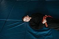 Boy resting in martial arts studio