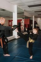 Coach and student practising kickboxing in studio