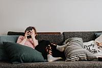 Girl playing with smartphone on couch