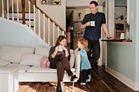 Mid adult couple having mug of coffee in living ro