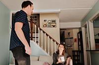 Mid adult couple in living room with mug of coffee
