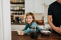 Female toddler and father at kitchen counter, port