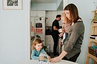 Female toddler at table with mother and baby broth