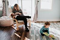 Female toddler playing in living room while mother