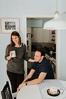 Mid adult couple having coffee break at table