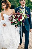 Bride and groom strolling on lakeside