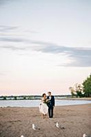 Romantic bride and groom barefoot on lakeside, Lak