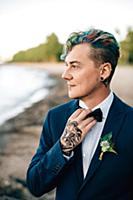 Bridegroom with hand tattoo looking out from lakes