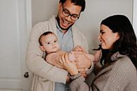Couple with baby daughter in diapers