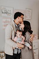 Couple with baby daughter in baby's room
